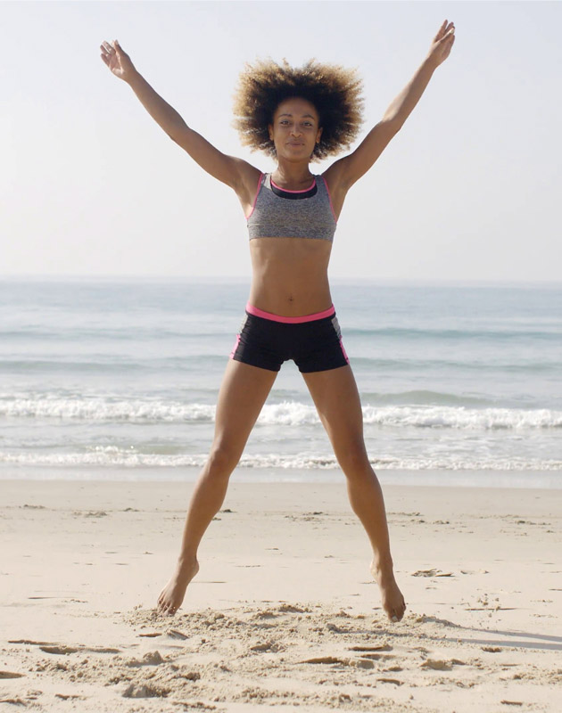 Woman Jumps On Beach